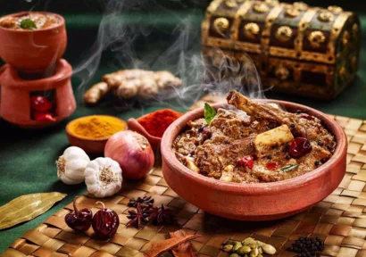 Delicous mutton chukka served in clay pot mixed with blend of spices showcasing Indian culture.