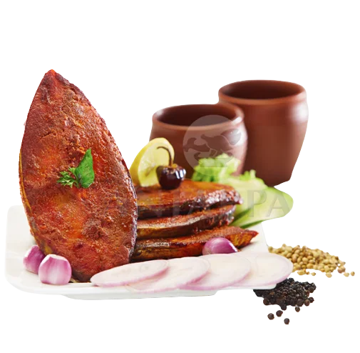 Tawa fried Flavorful fish coated well with spices arranged and served with onion and Indian spices.